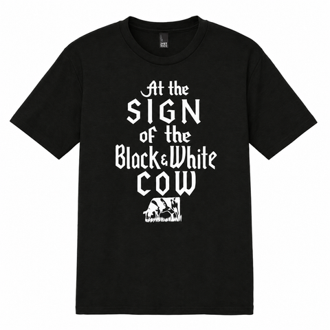 Black & White Cow design printed in white on a black T-shirt, front view.